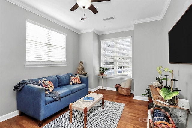 living room featuring ceiling fan, crown molding, and wood-type flooring