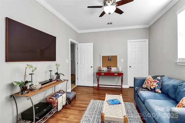 living room with ceiling fan, crown molding, and hardwood / wood-style flooring