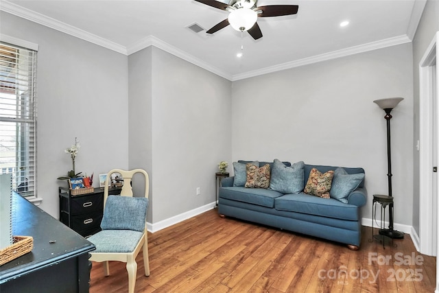 living area with ceiling fan, hardwood / wood-style flooring, and crown molding