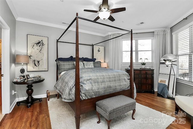 bedroom featuring ceiling fan, hardwood / wood-style floors, and ornamental molding