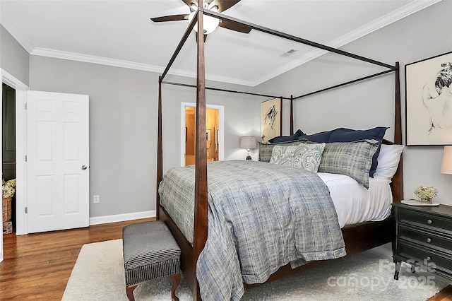 bedroom with ceiling fan, hardwood / wood-style floors, and ornamental molding