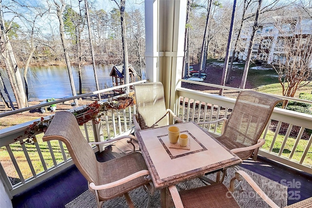 sunroom / solarium featuring a wealth of natural light and a water view