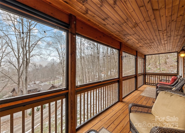 unfurnished sunroom with wooden ceiling