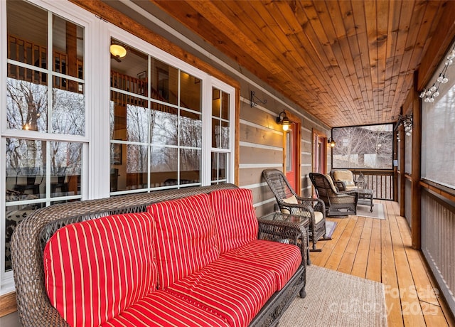 sunroom / solarium featuring wood ceiling