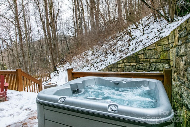 exterior space featuring a wooden deck and a hot tub