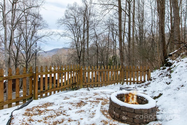 yard layered in snow featuring a mountain view