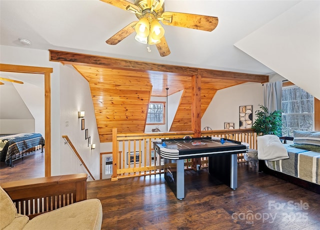 recreation room with vaulted ceiling with beams, dark hardwood / wood-style floors, and ceiling fan