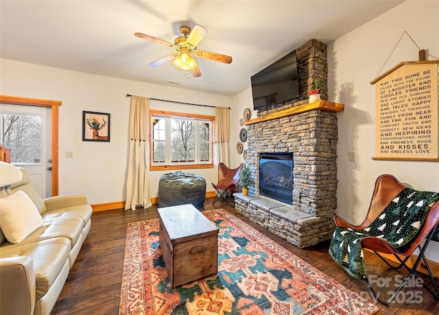 living room with ceiling fan, dark wood-type flooring, and a fireplace