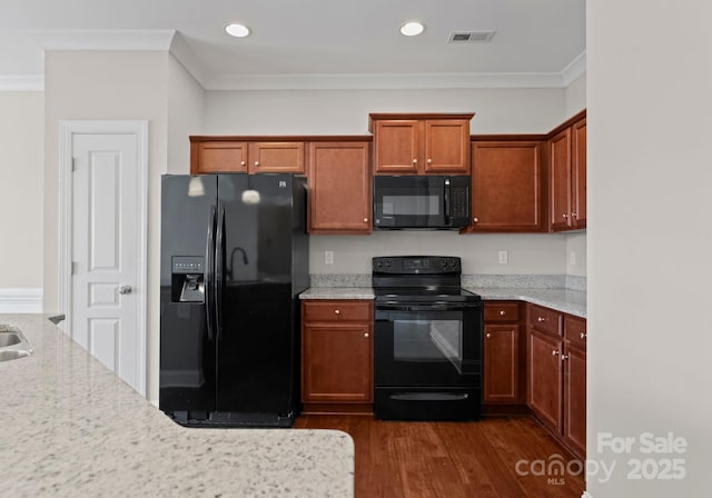 kitchen with black appliances, dark hardwood / wood-style flooring, light stone countertops, and ornamental molding