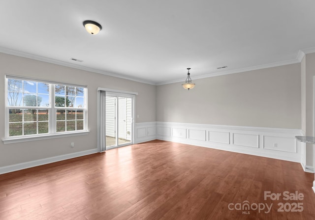 unfurnished room with wood-type flooring and crown molding