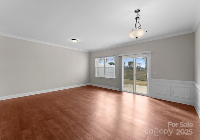 unfurnished room featuring ornamental molding and hardwood / wood-style floors