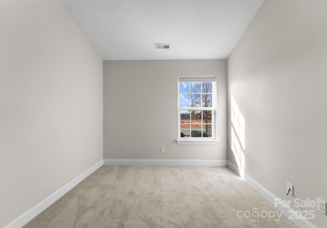 spare room with light colored carpet