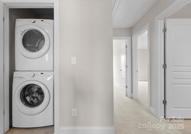 laundry area with stacked washer and clothes dryer and light colored carpet