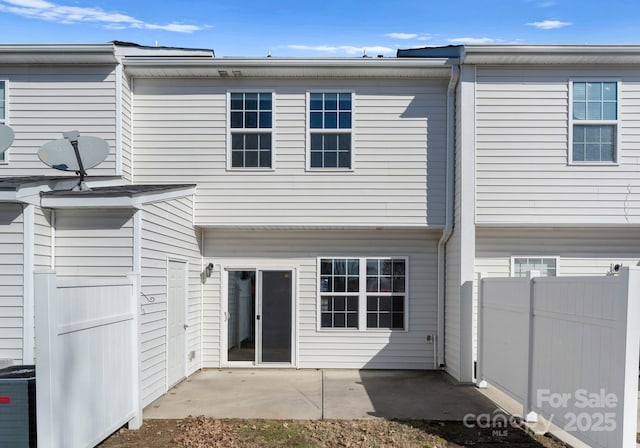 rear view of house featuring a patio area and central AC unit