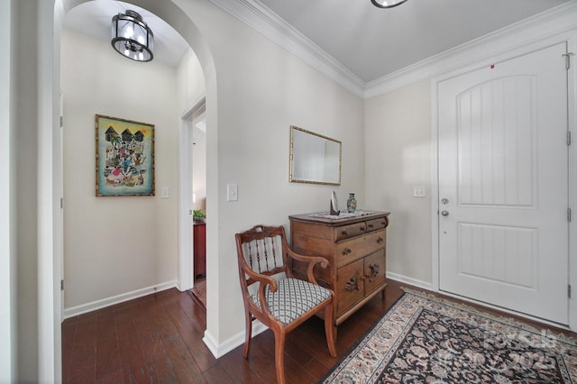 foyer with dark wood-type flooring and crown molding