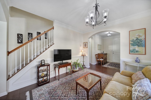 living room featuring dark hardwood / wood-style floors, a chandelier, and ornamental molding