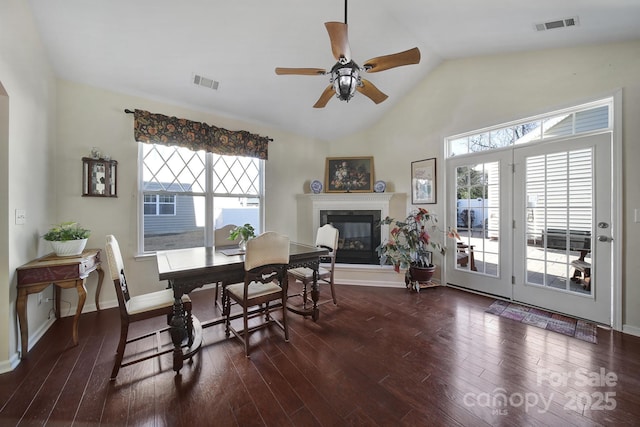 dining room featuring vaulted ceiling, ceiling fan, and dark hardwood / wood-style flooring