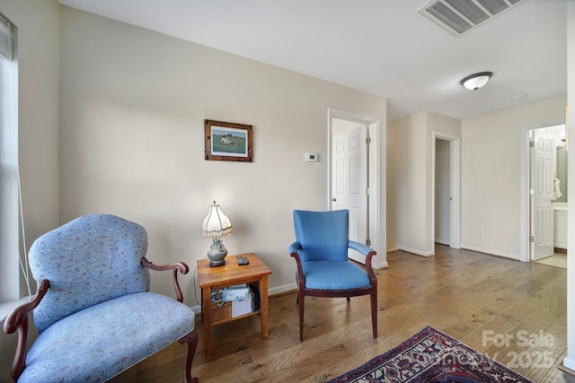 living area with hardwood / wood-style flooring