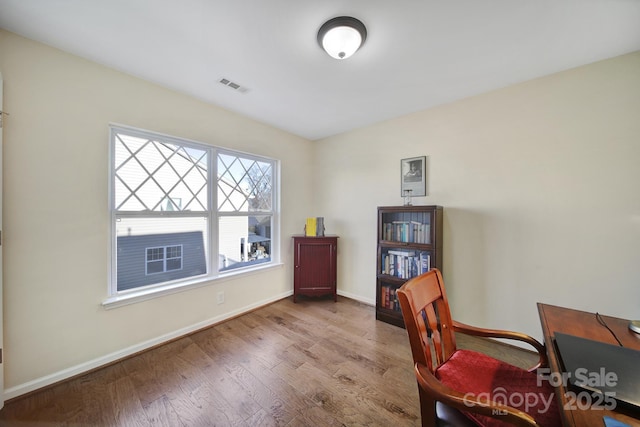 home office with light hardwood / wood-style flooring