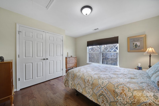 bedroom with a closet and dark hardwood / wood-style flooring