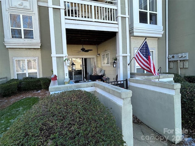 entrance to property featuring ceiling fan and a balcony