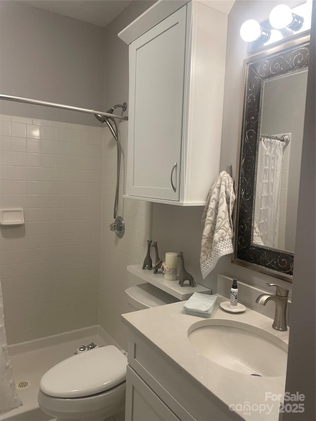 bathroom with vanity, toilet, and curtained shower