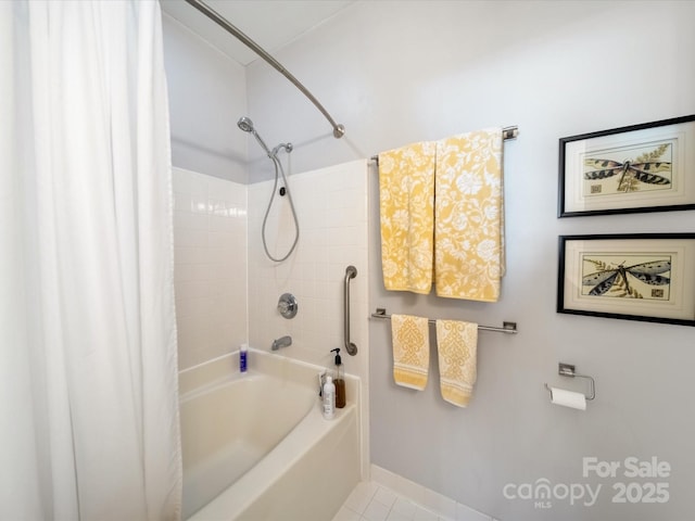 full bath featuring tile patterned flooring, baseboards, and shower / bath combo with shower curtain