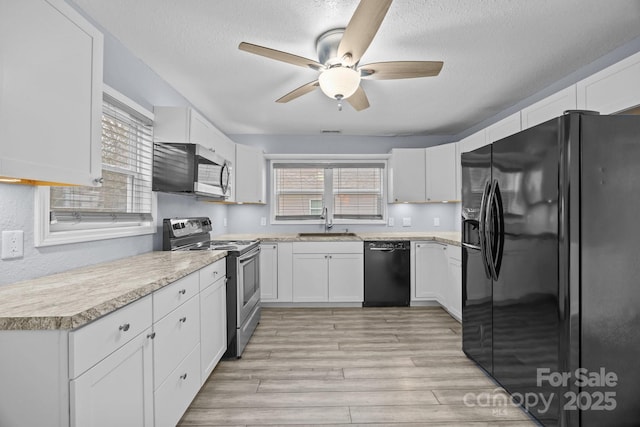 kitchen featuring ceiling fan, sink, a textured ceiling, white cabinets, and black appliances