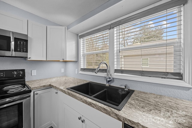 kitchen featuring white cabinetry, range with electric stovetop, lofted ceiling, and sink