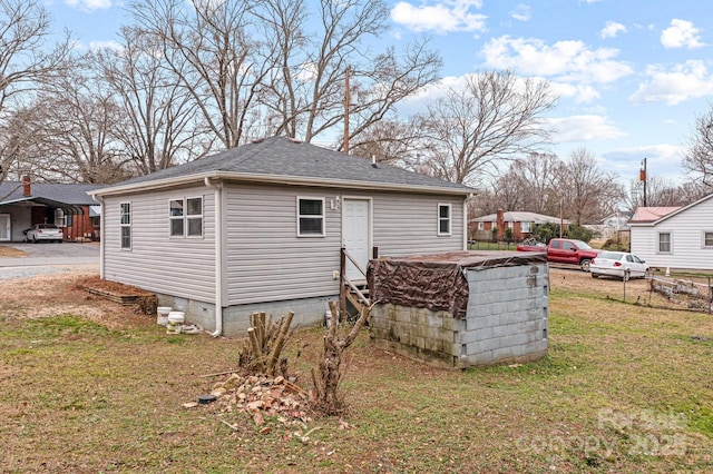 rear view of house with a yard