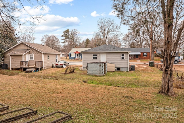 exterior space featuring central AC unit and a yard