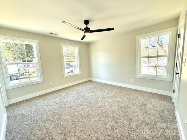 empty room featuring carpet flooring and ceiling fan