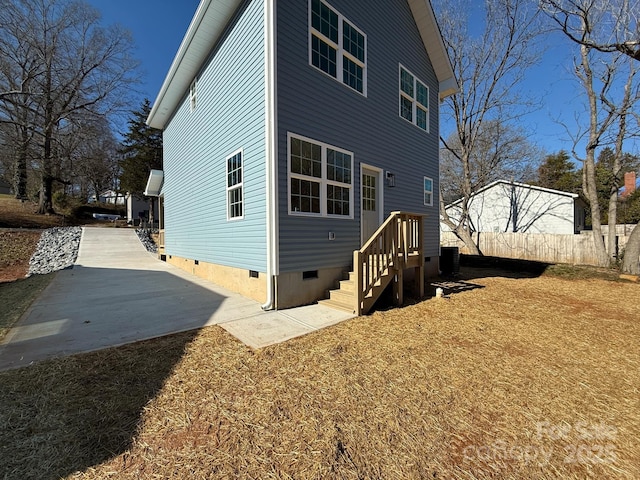 back of property with central AC and a patio area