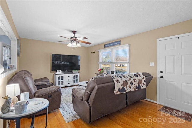 living room with ceiling fan and light hardwood / wood-style floors