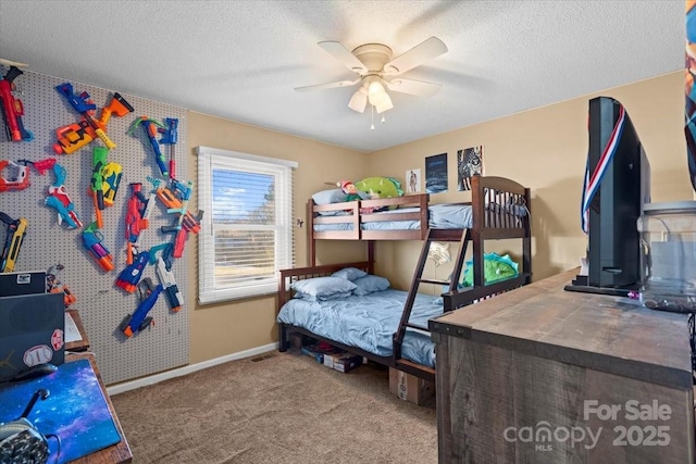 carpeted bedroom featuring a textured ceiling and ceiling fan