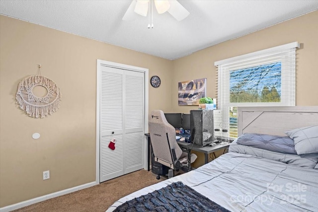 bedroom with ceiling fan, a closet, and carpet