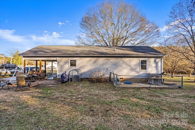 back of property with a yard and a patio