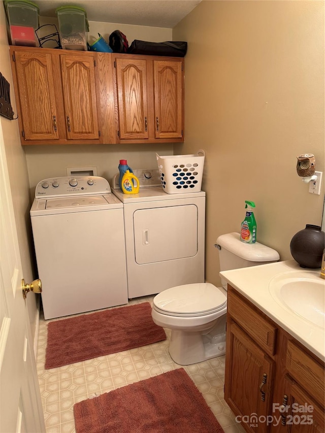 bathroom with vanity, toilet, and independent washer and dryer