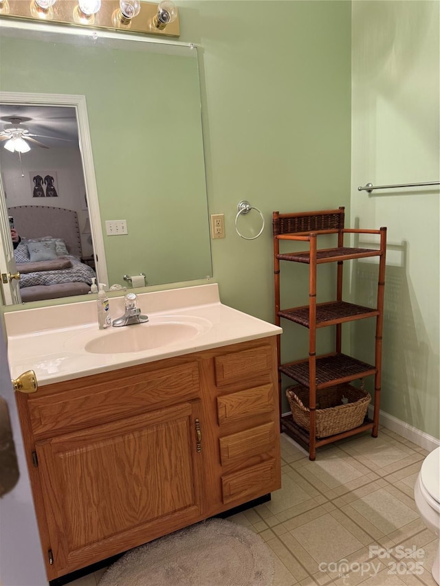 bathroom with ceiling fan, tile patterned flooring, vanity, and toilet