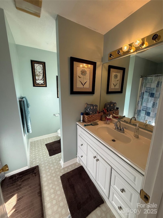 bathroom with vanity and toilet