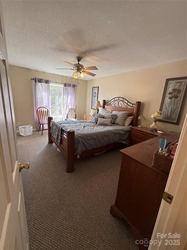 carpeted bedroom with ceiling fan and a textured ceiling