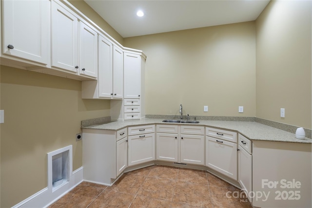 washroom with sink, cabinets, electric dryer hookup, and light tile patterned floors