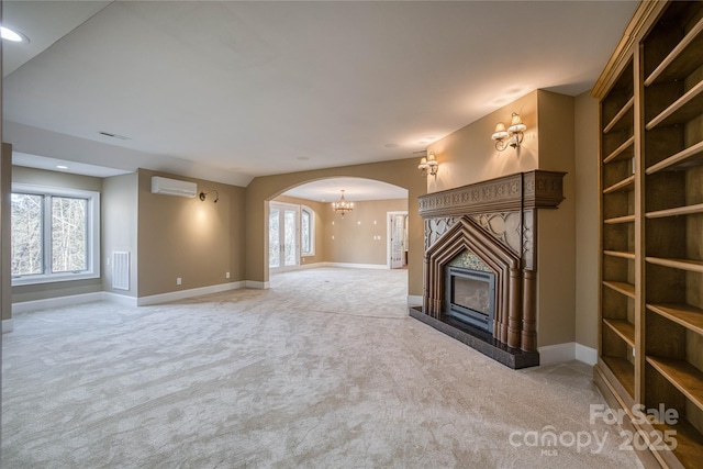 unfurnished living room with light carpet and an AC wall unit