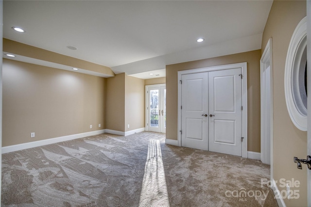 carpeted empty room with french doors