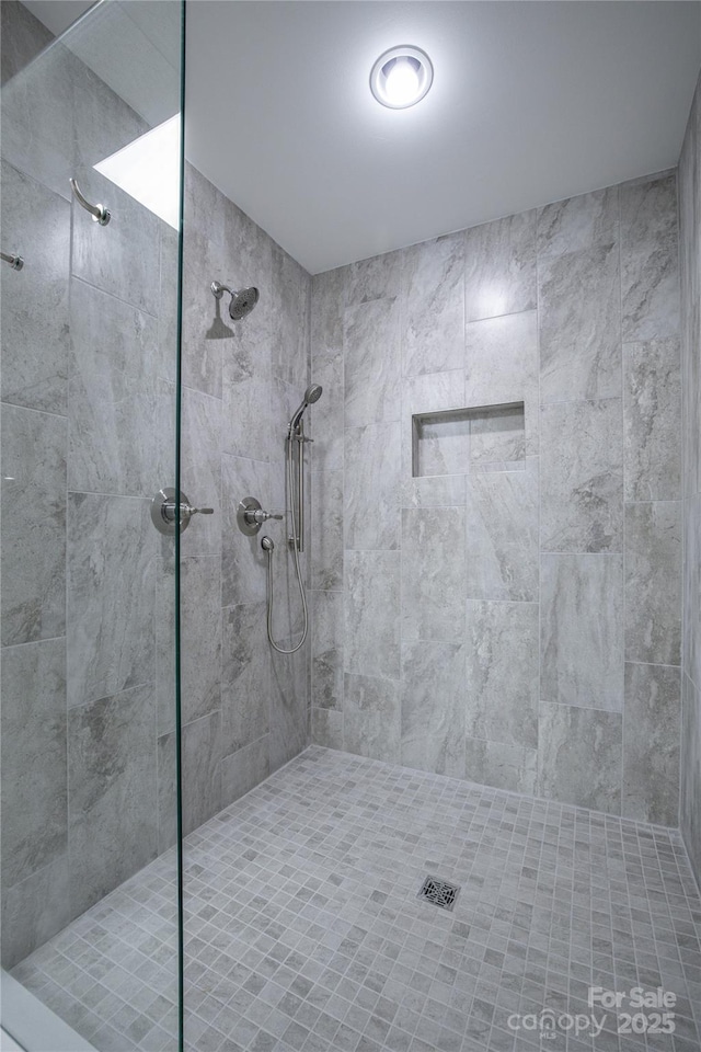 bathroom with a tile shower