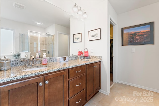 bathroom featuring vanity, tile patterned floors, and a shower with shower door