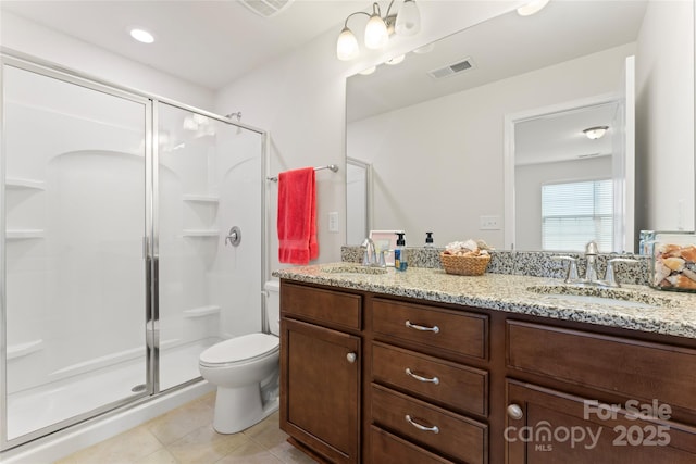 bathroom with tile patterned flooring, an enclosed shower, vanity, and toilet