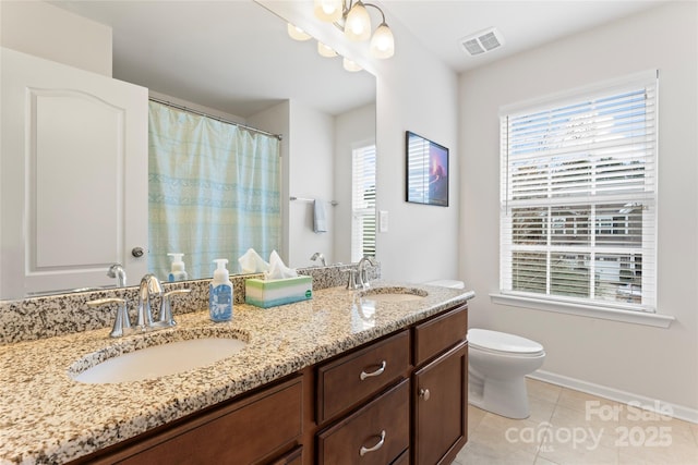 bathroom with toilet, an inviting chandelier, tile patterned flooring, and vanity