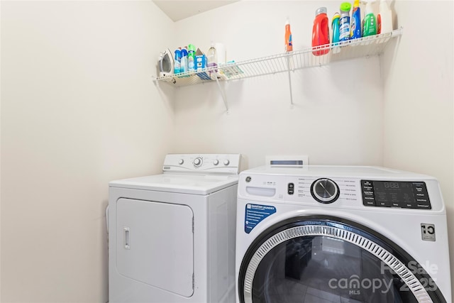 washroom with washing machine and dryer