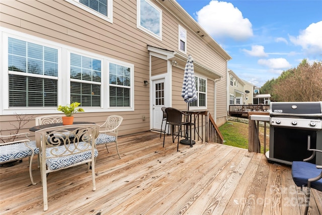 wooden deck featuring a grill